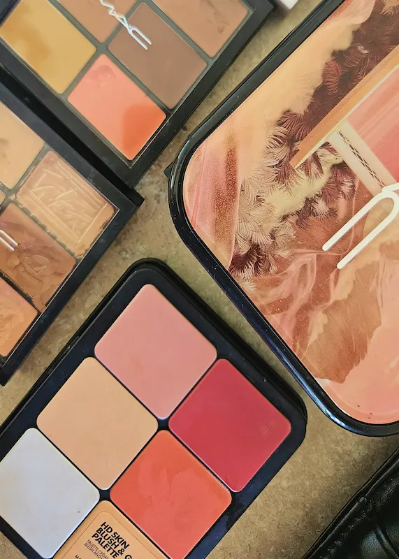 Professional makeup palettes and beauty products used for bridal and event makeup