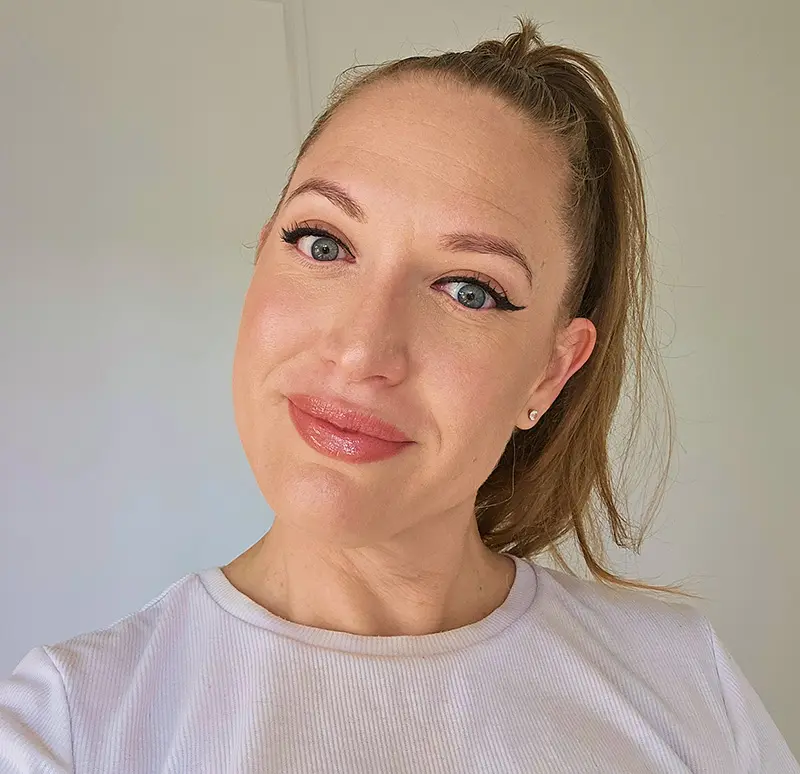 Portrait of professional makeup artist with natural glam makeup and ponytail hairstyle