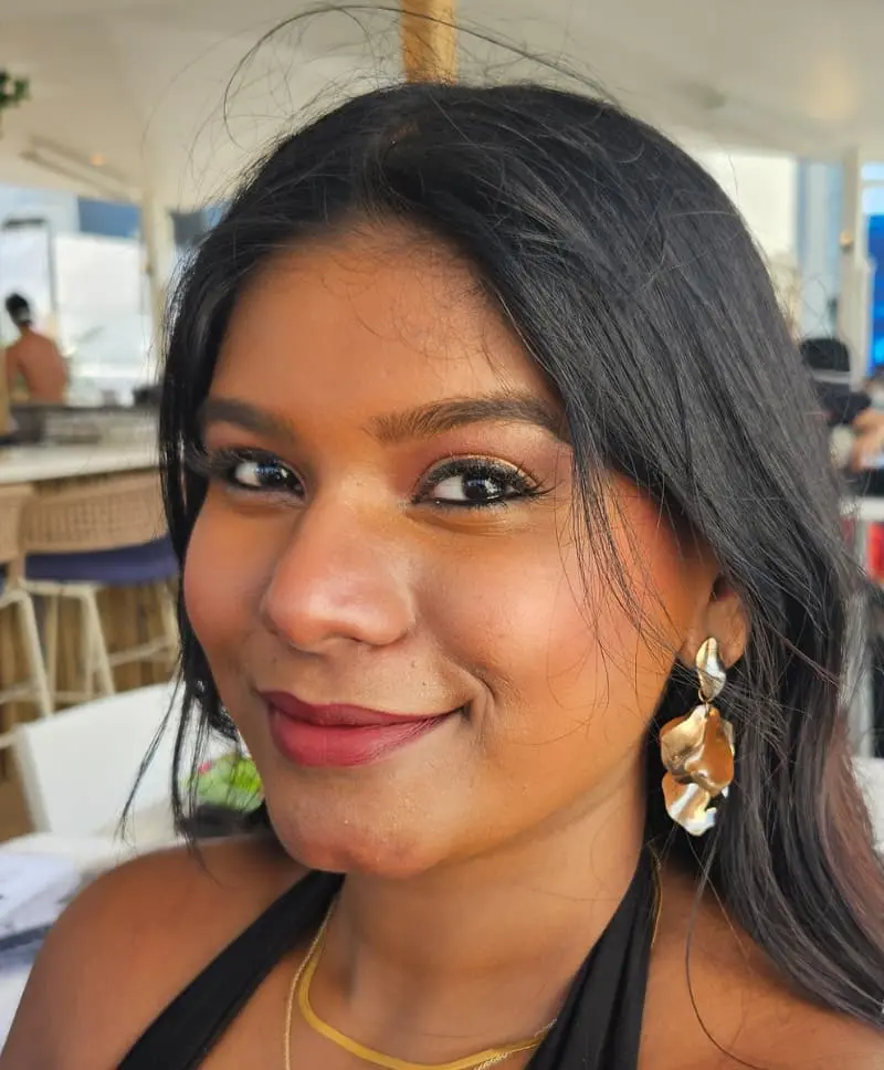 Woman with radiant glam makeup and gold earrings at special event
