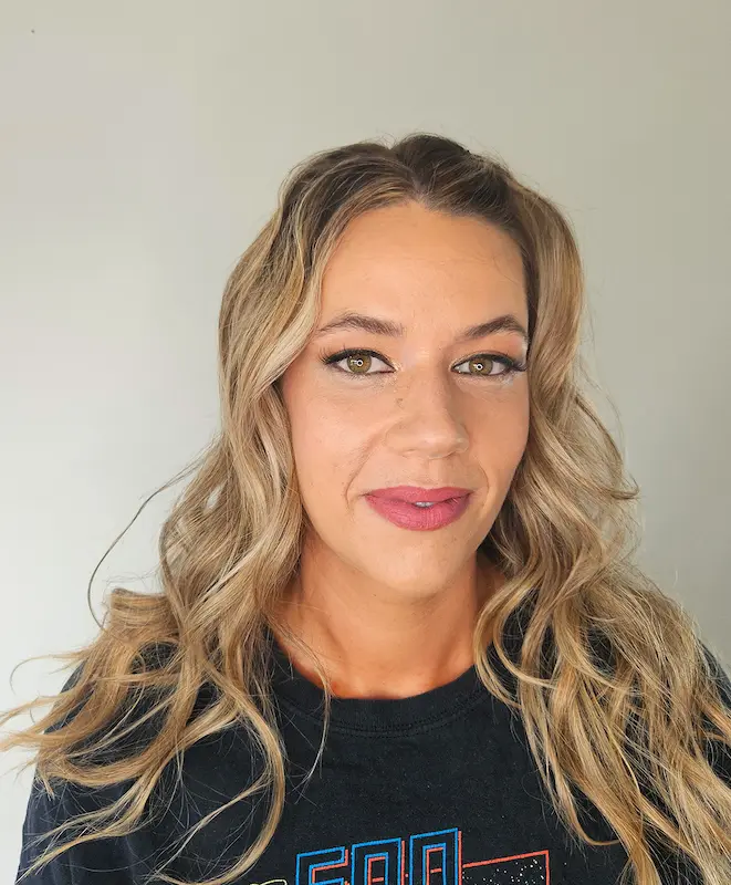 Woman with soft glam makeup and styled blonde wavy hair