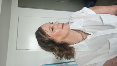 Mature woman with soft glam makeup and curled hairstyle during makeup session on the Gold Coast