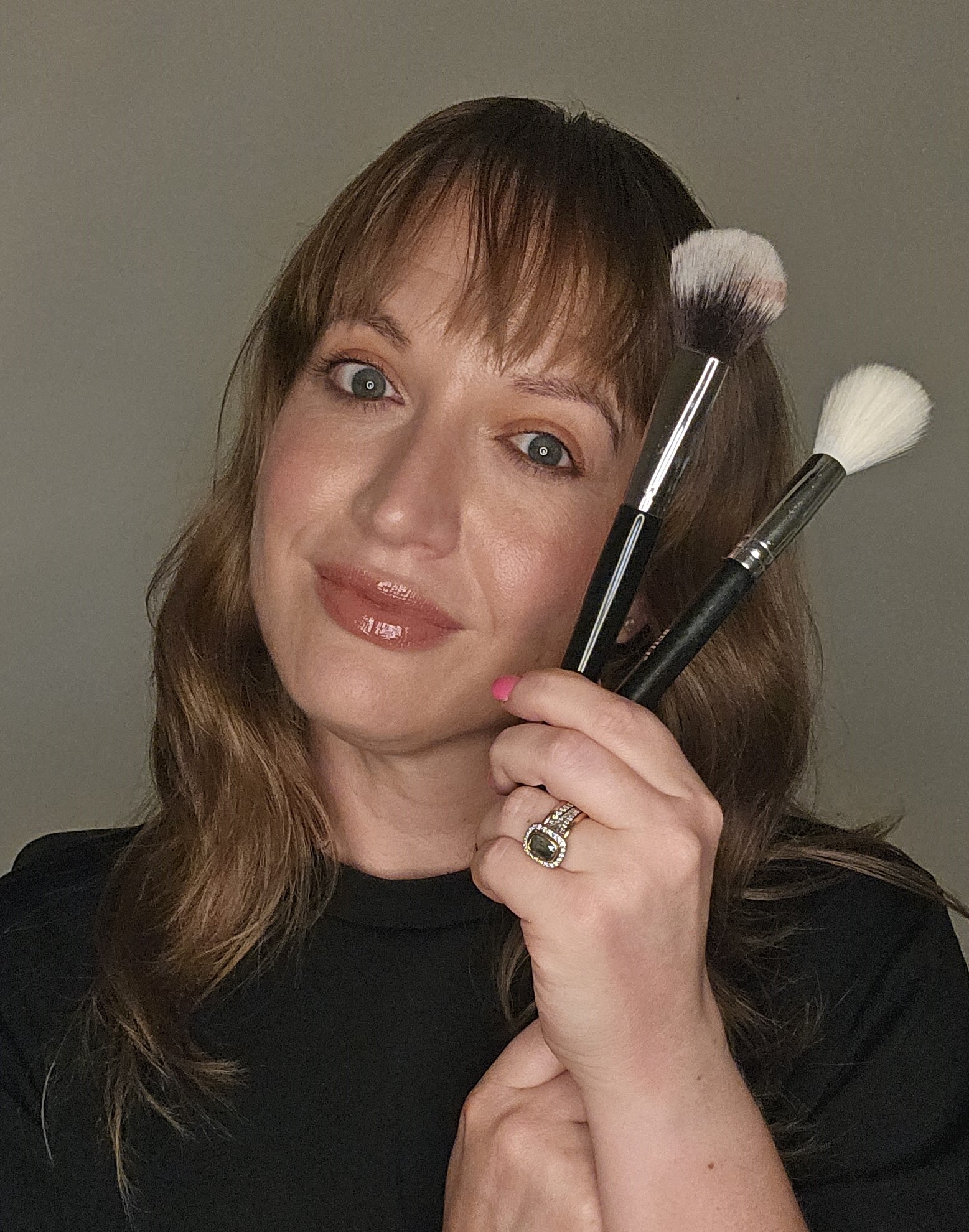 Makeup artist applying lip color during bridal beauty preparation