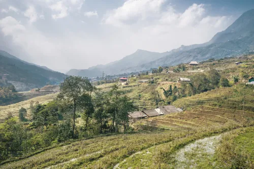 Terraced farmland and scattered homes in a mountain valley