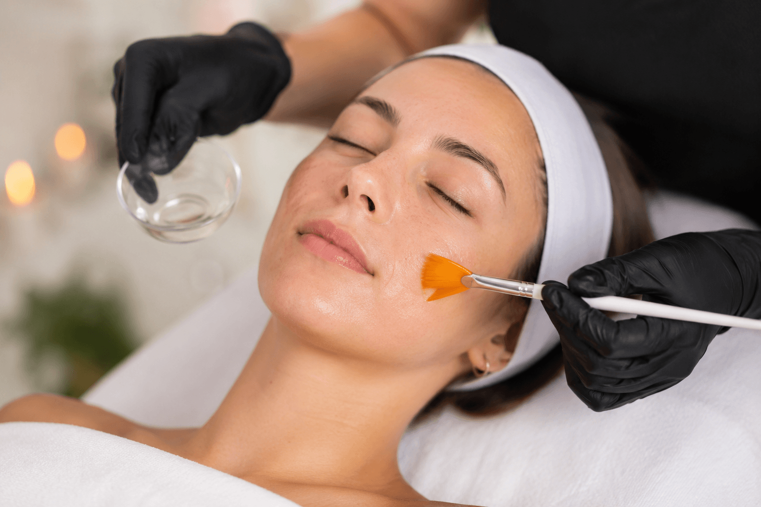 Esthetician applying a chemical peel treatment to a client's skin at a Gold River, CA skincare studio