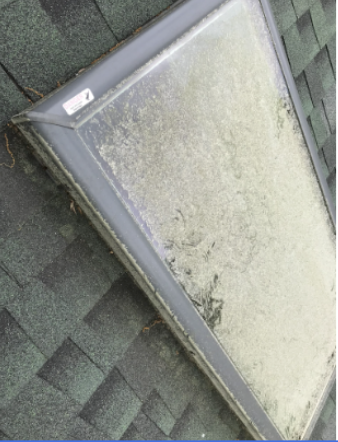 Dirty roof window panel prior to Crystal Clear Solutions cleaning