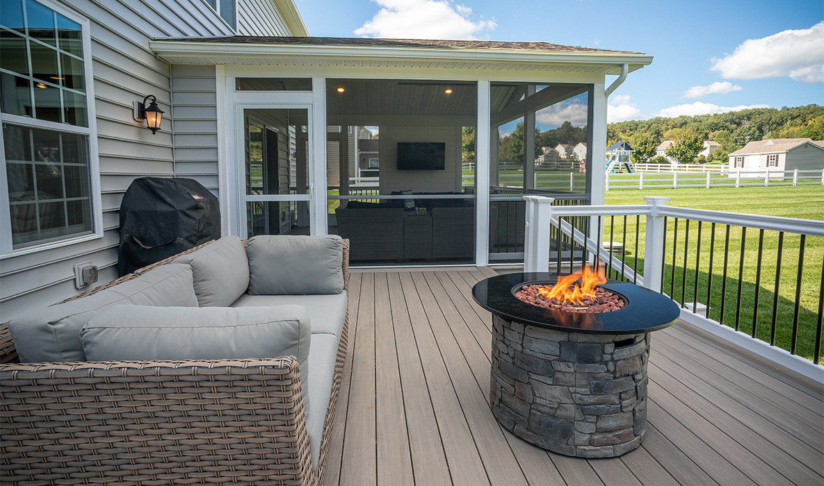 Outdoor living deck with pergola and patio furniture by Knot Just Decks