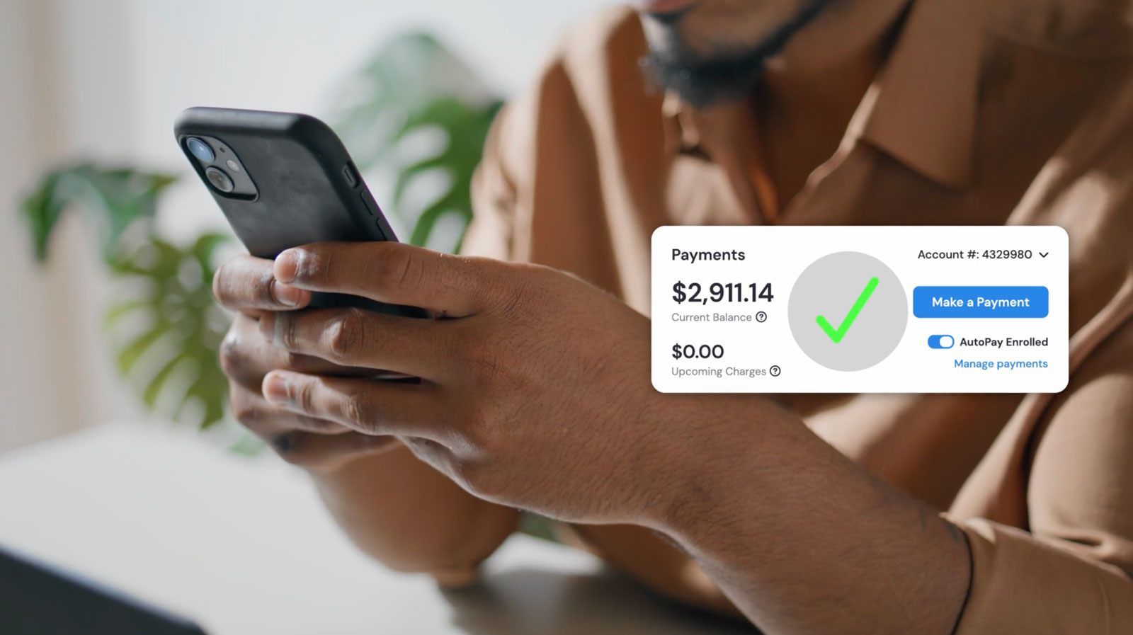 Man using phone with digital overlay showing $2,911.14 payment balance and AutoPay enrolled.