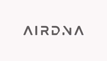 Logo of the brand AIRDNA with modern, stylized gray letters on a light background.
