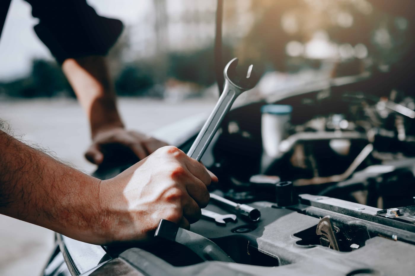 car mechanic holding a wrench