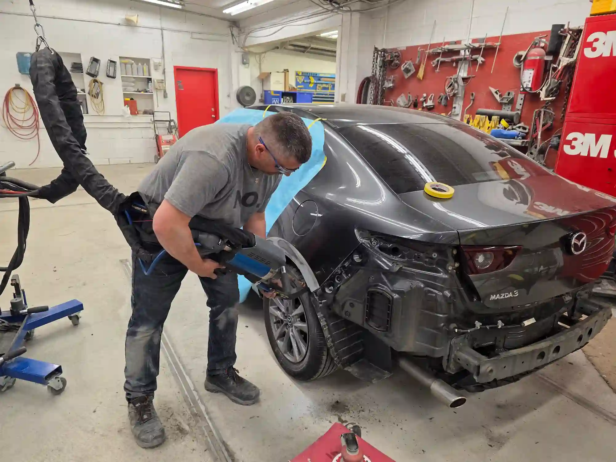 repair man fixing car in repair station under lift