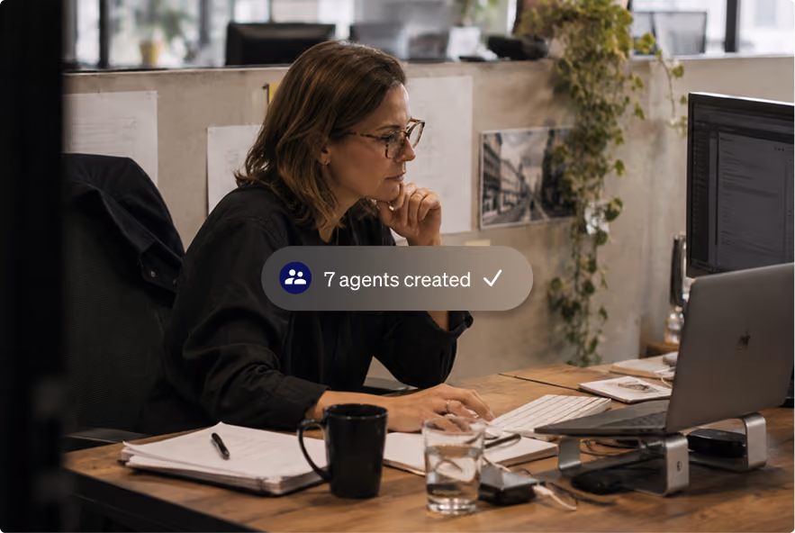 Agent working at a desk with a computer in an office.