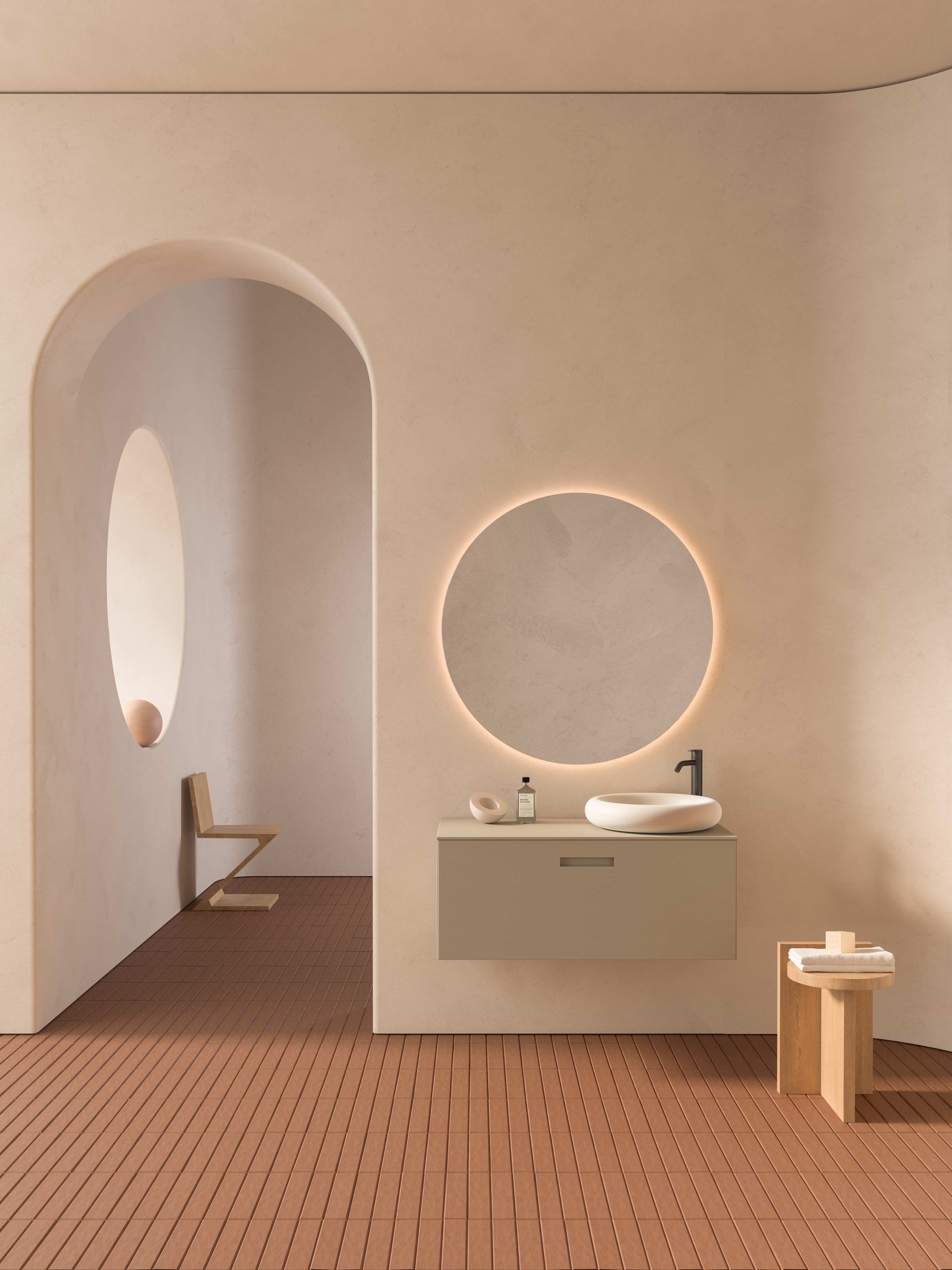 Inbani Ease wastafelmeubel met ronde spiegel boven terracotta tegelvloer