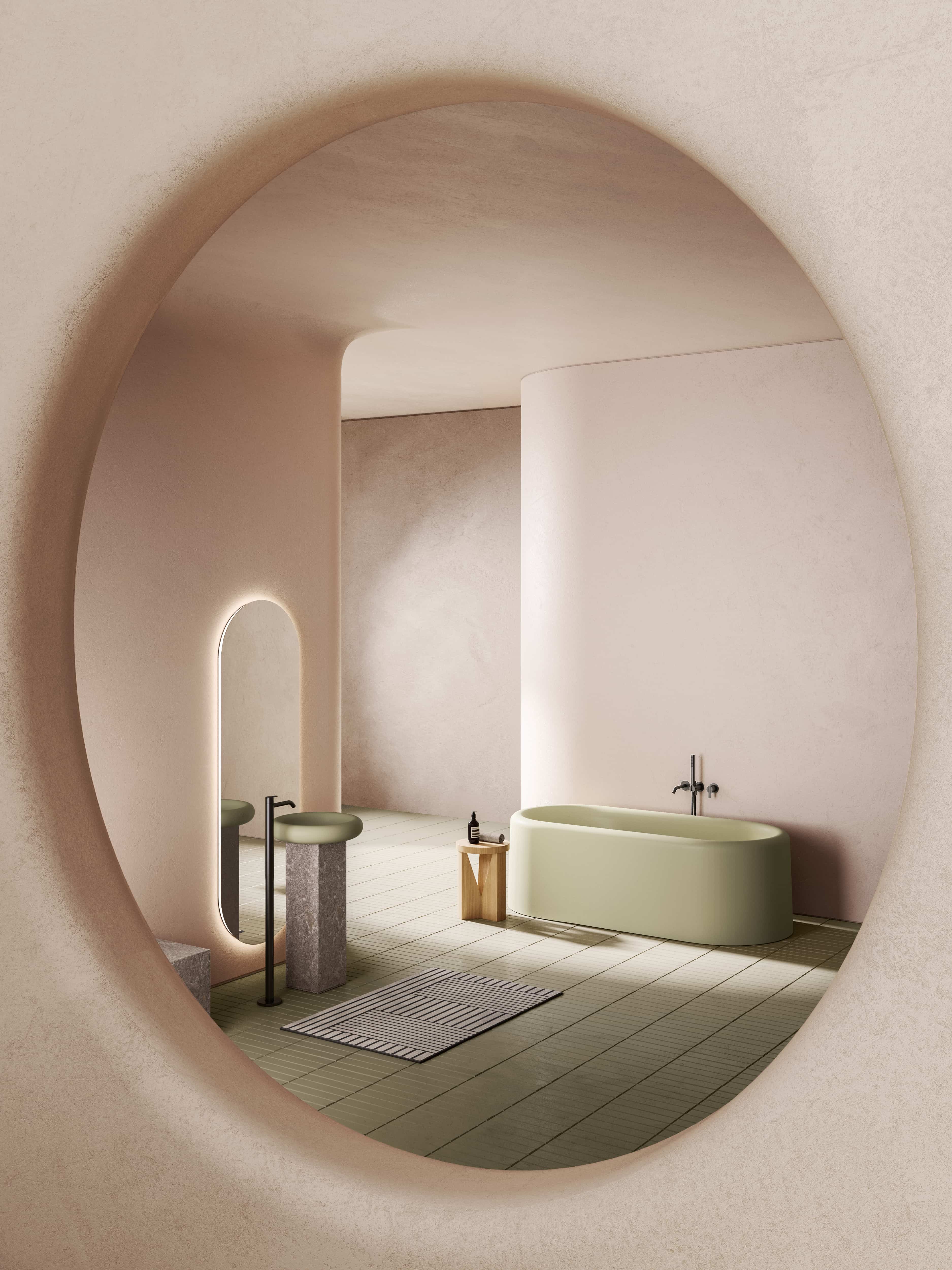 Inbani Ease badkamer met groen bad en wastafel gezien in ronde spiegel