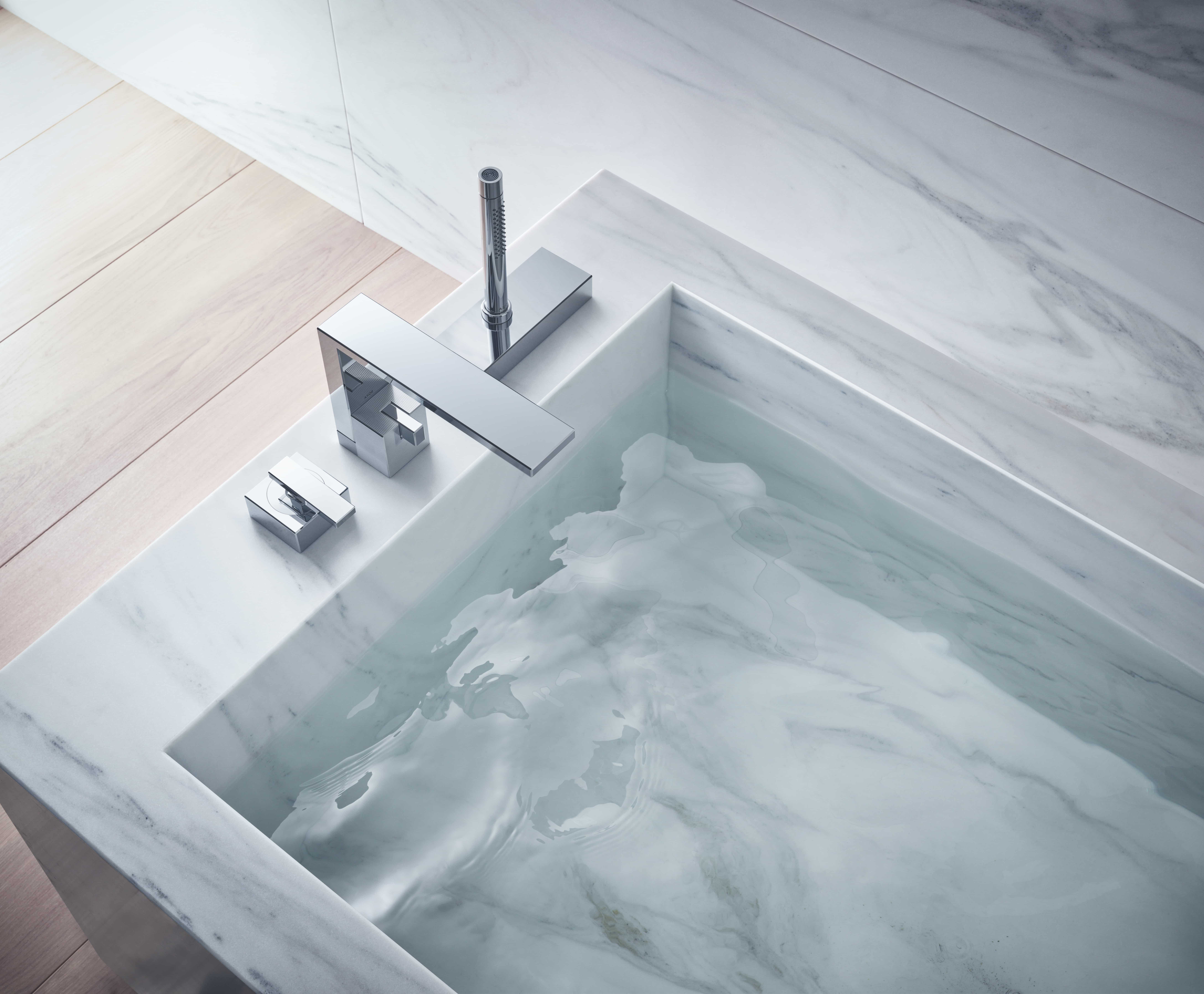 Axor Edge badkraan met mengkraan boven marmeren ligbad gevuld met water