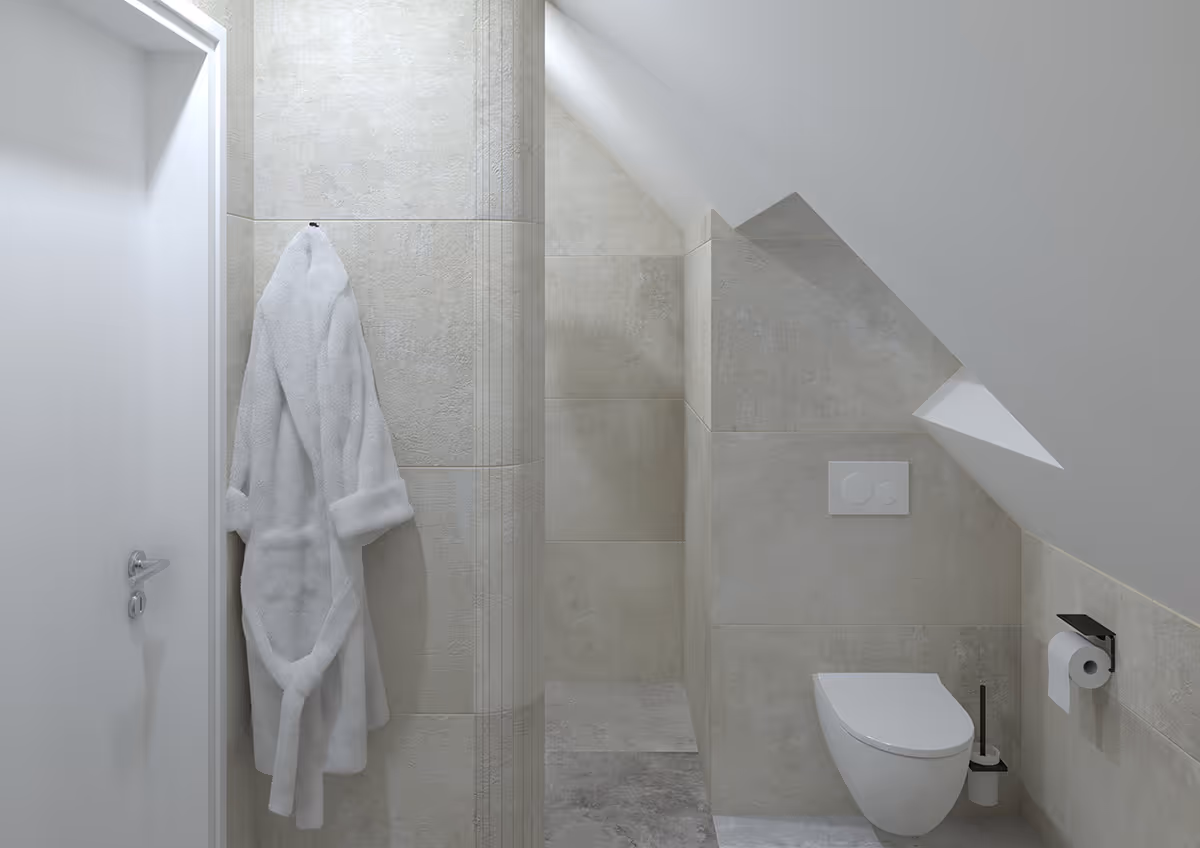 Badjas aan haak en wandcloset onder een schuin plafond in Japandi badkamer op Texel