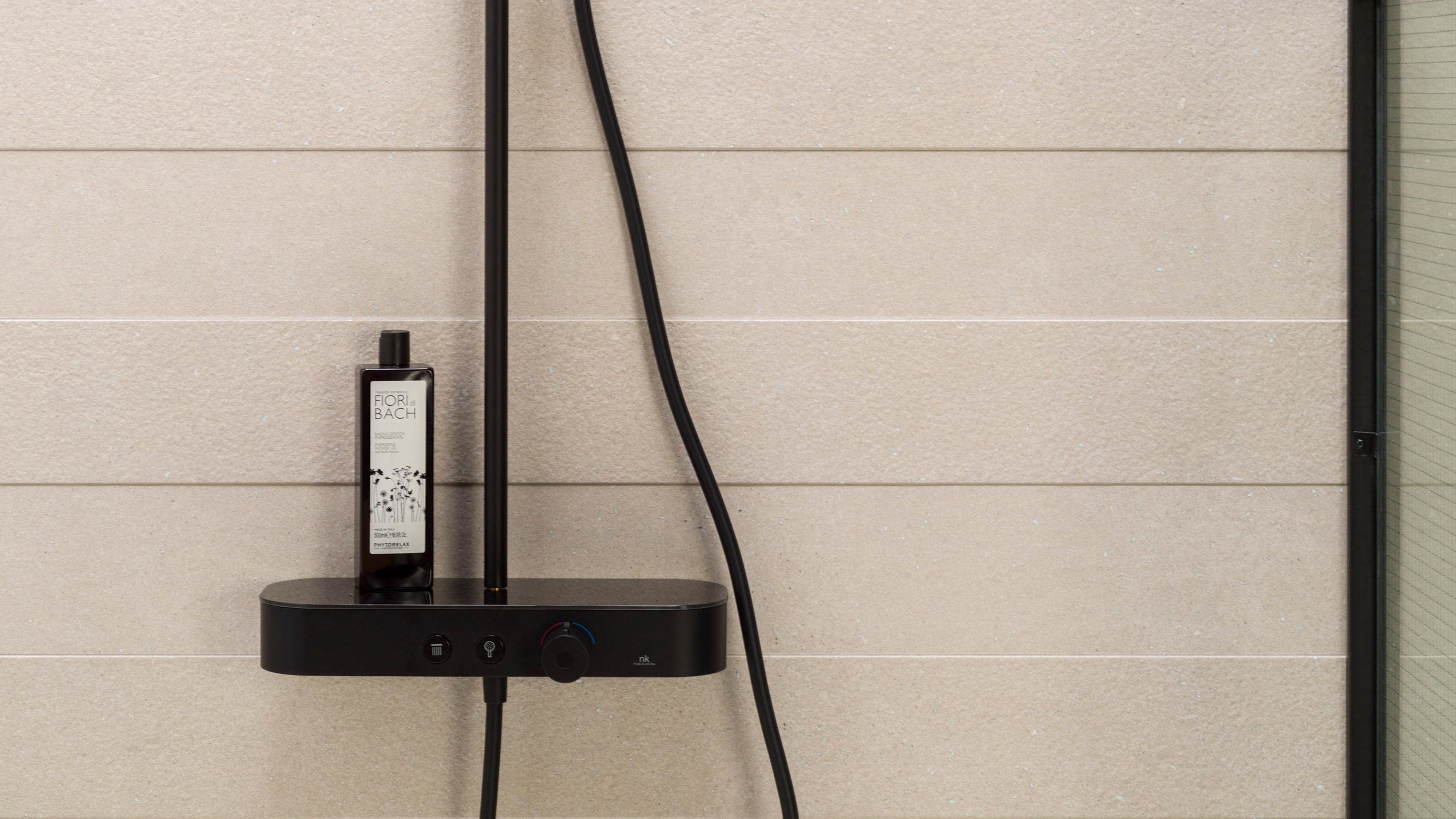 Porcelanosa Line Terra Bone tegel als douchewand met zwarte douchekraan