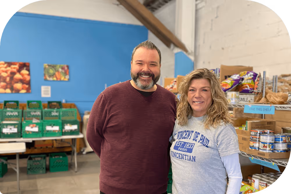 Employees of Saint Vincent de Paul overseeing food distribution.
