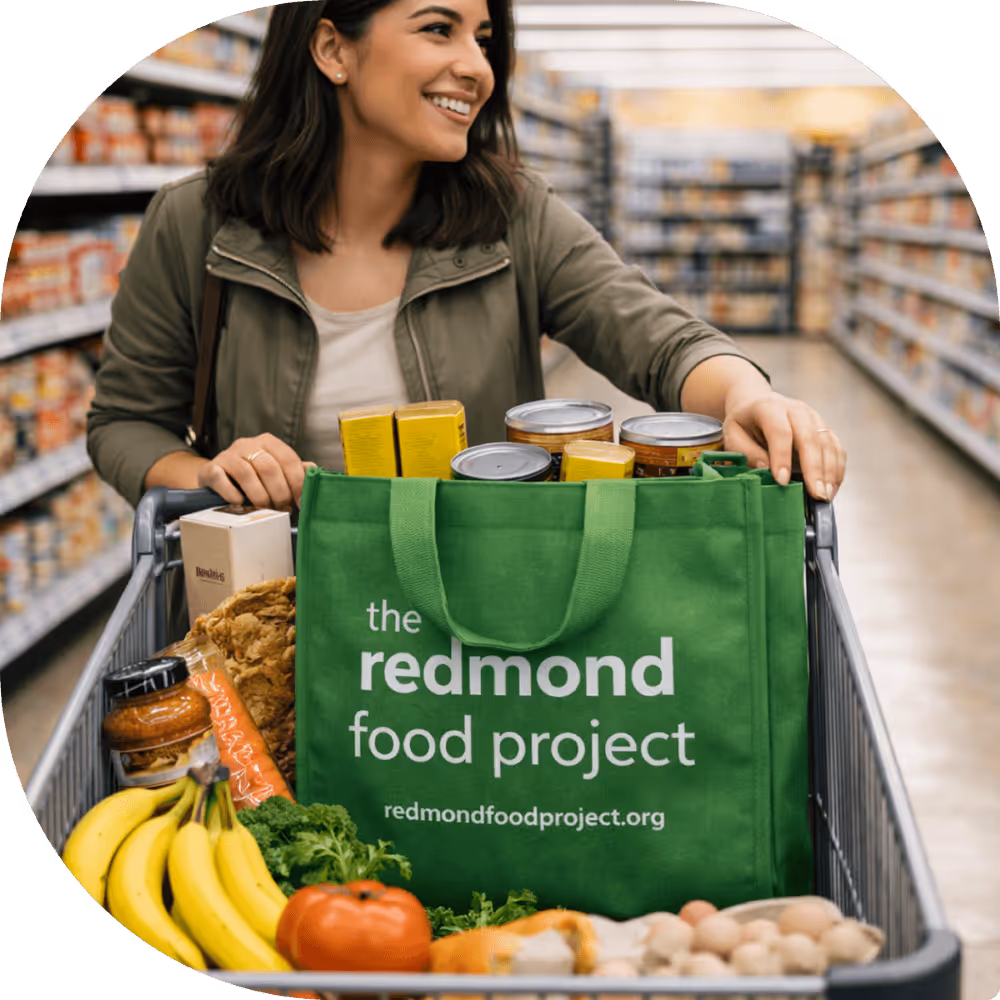 A woman in a grocery store filling her cart with food to donate.