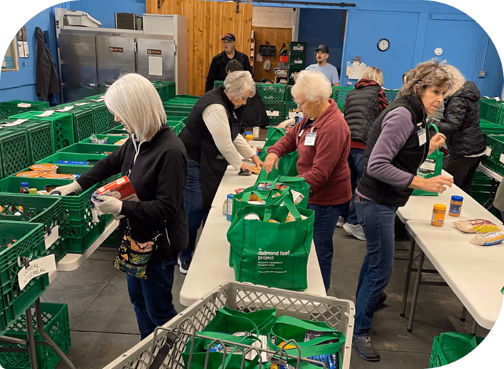 Numerous volunteers taking time to organize food donations for Redmond.