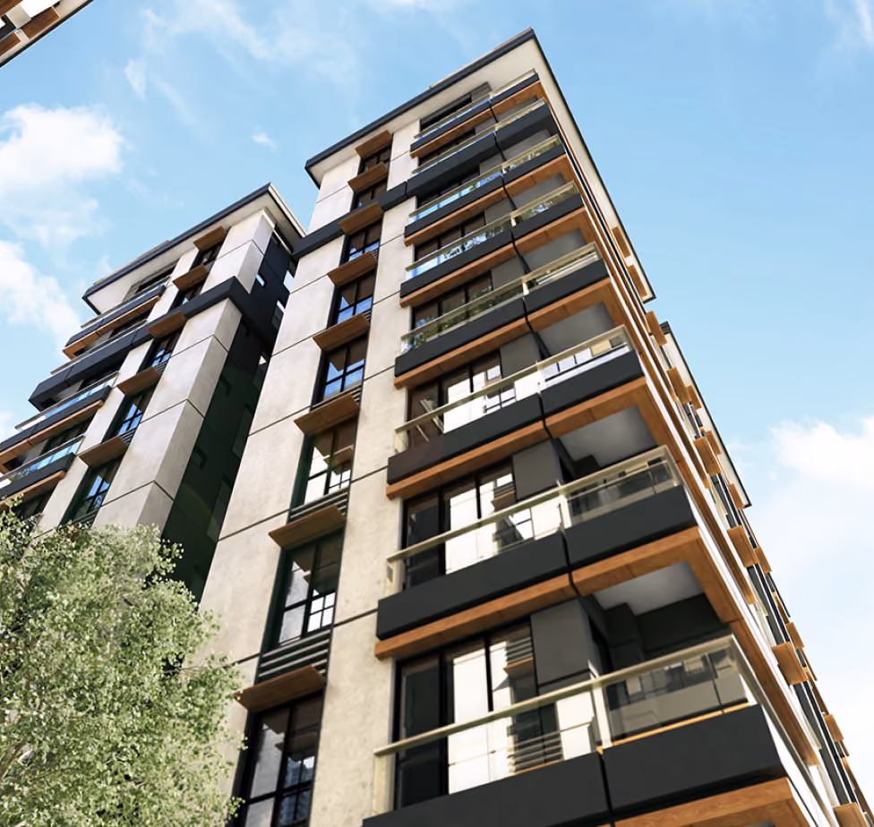 Modern multi-story residential building with balconies and large windows under a blue sky.