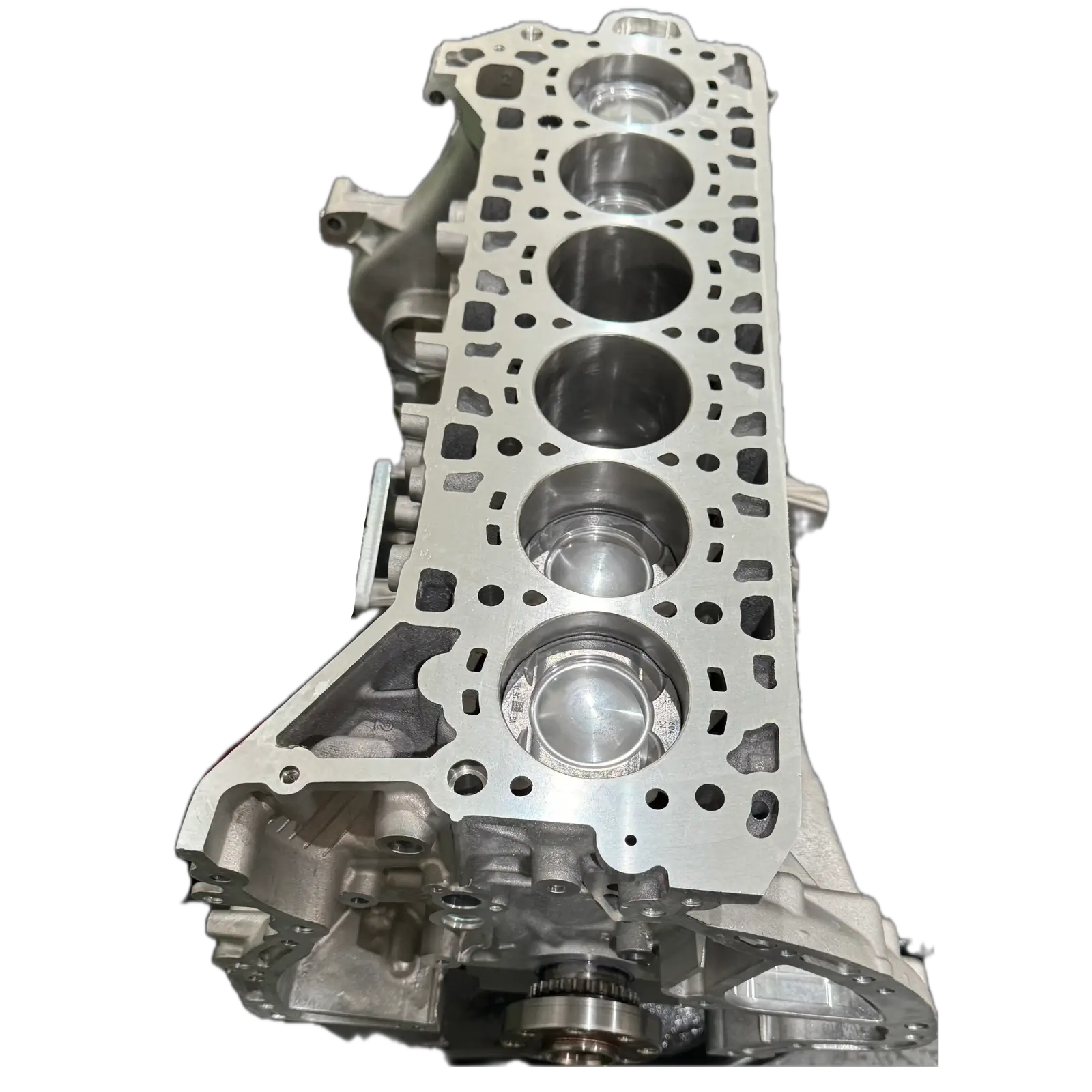 Close-up of a metallic Range Rover engine block showing five cylindrical piston chambers.