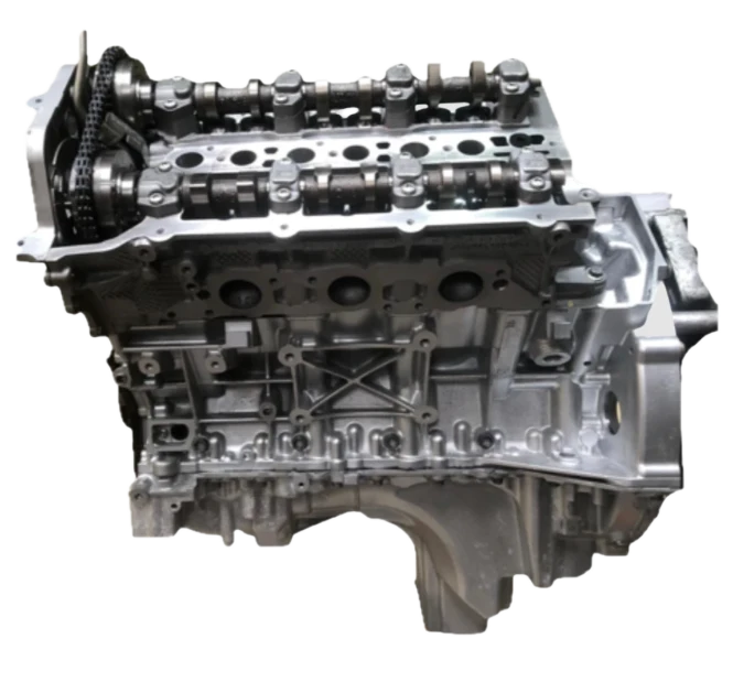 Silver Range Rover engine block with visible camshafts and timing chain.