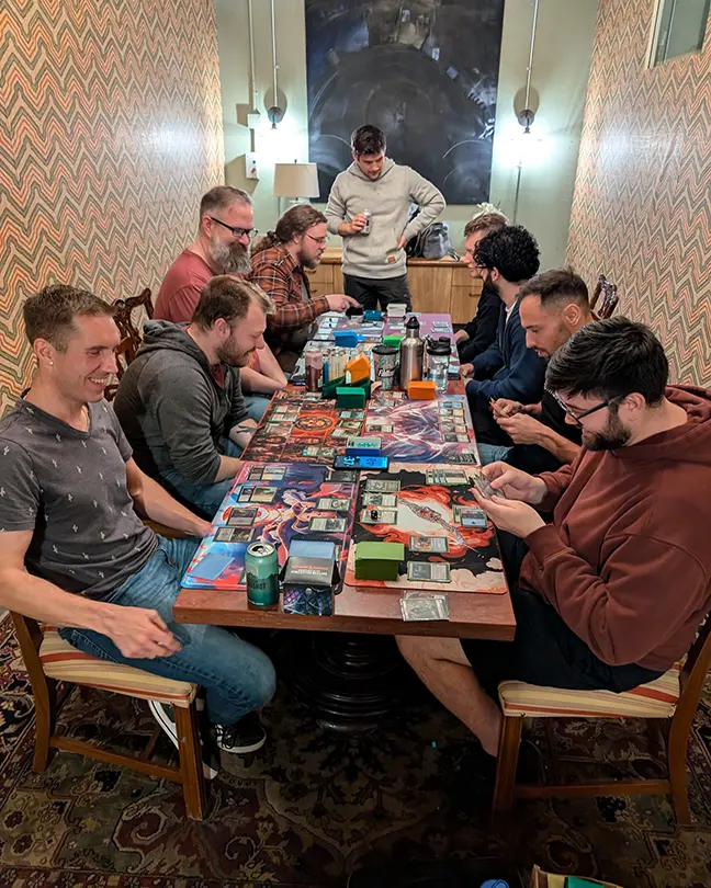 TCG Machines staff playing Magic: The Gathering at a company games day event