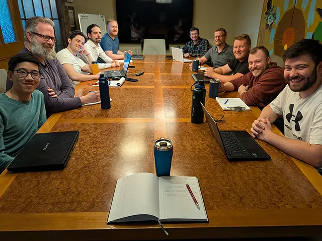 TCG Machines team members around a boardroom table