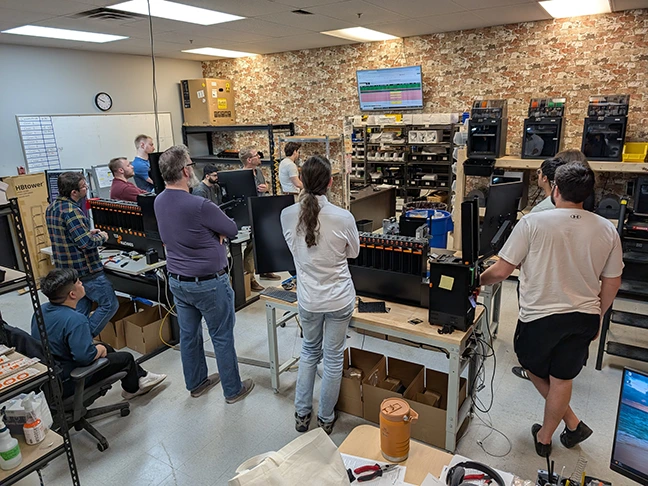 TCG Machines team members during a production stand-up meeting