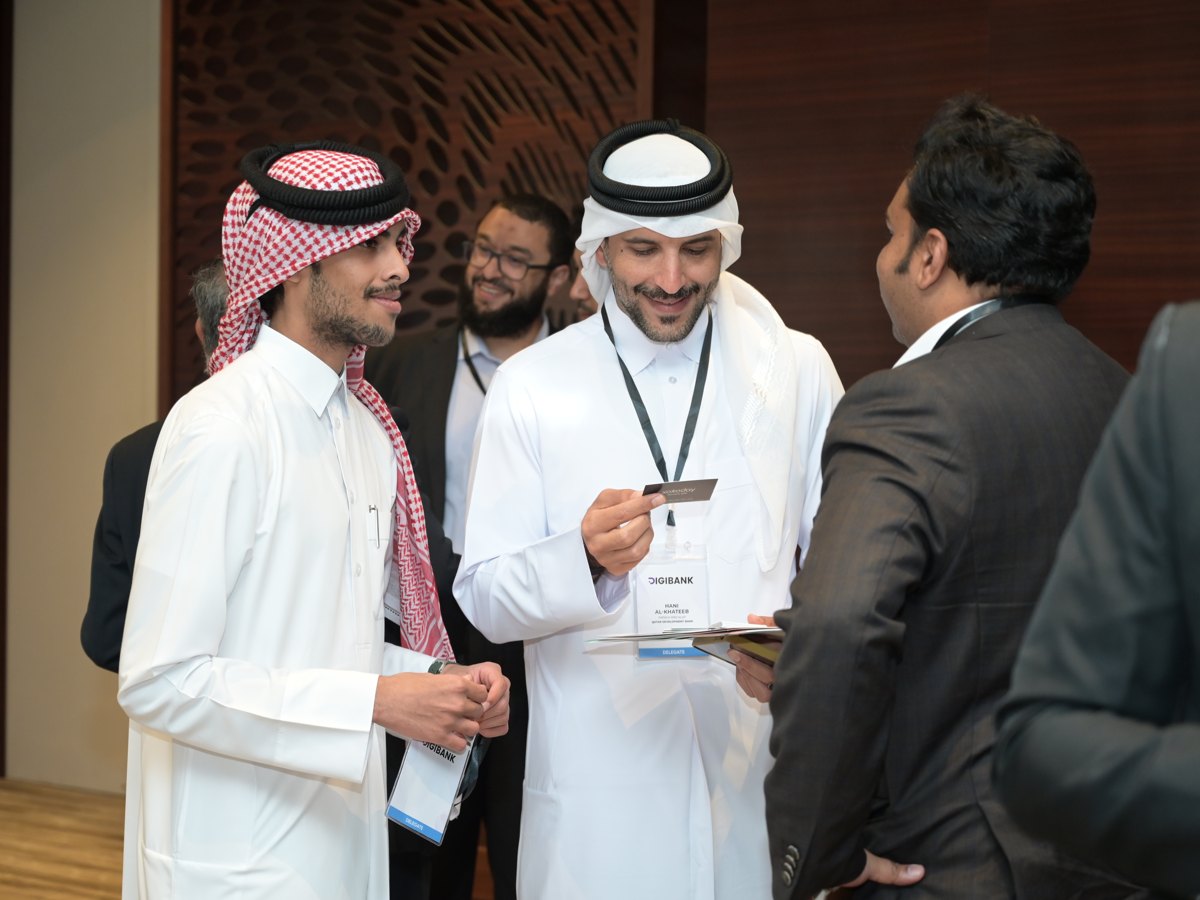 Delegates exchanging business cards at a PMG Events summit
