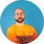 Man in orange shirt with arms crossed