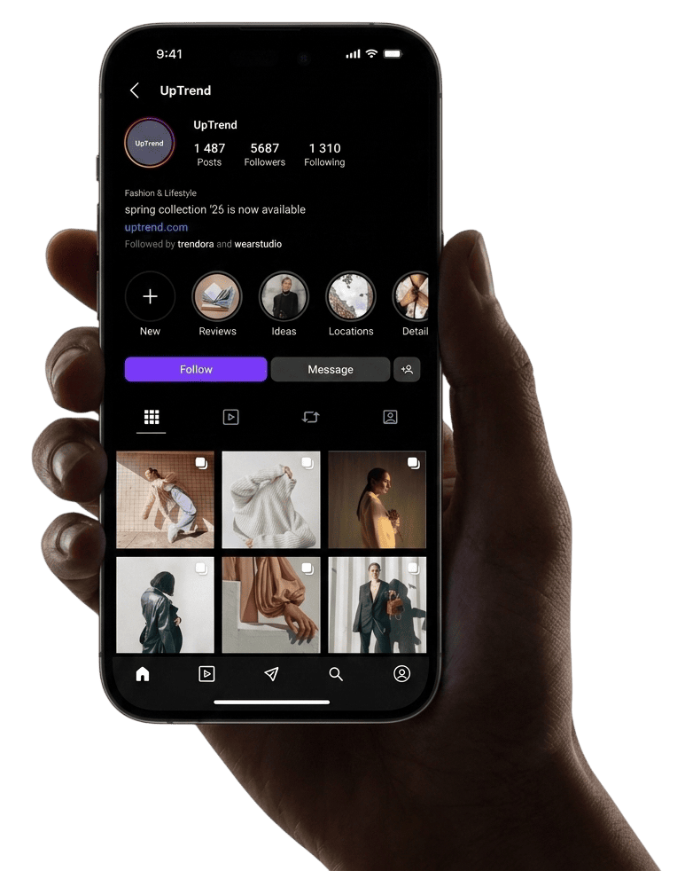 Hand holding a smartphone displaying the UpTrend Instagram profile with fashion images and follow button.