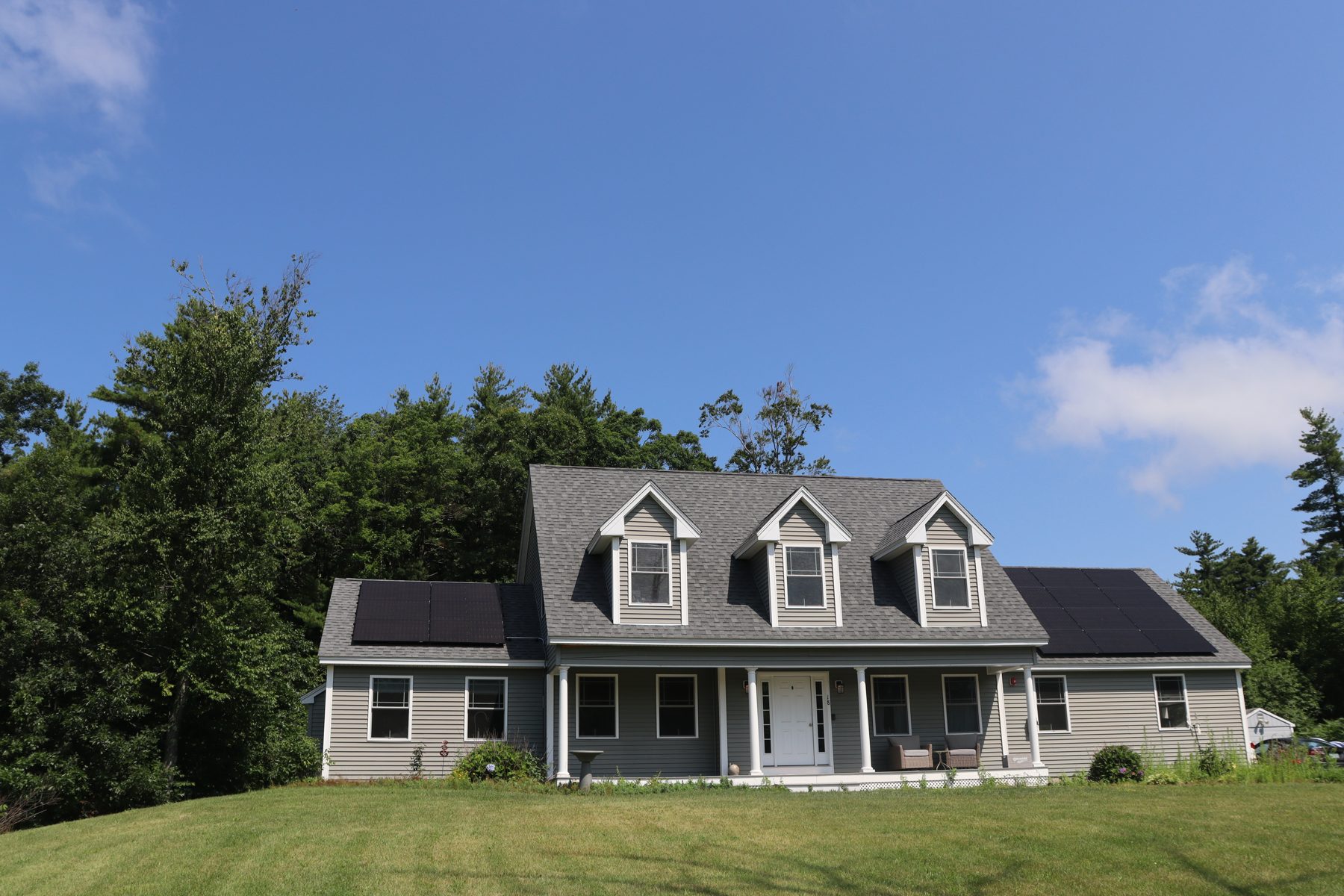 Completed WattsUp solar installation on a gray cape-style home