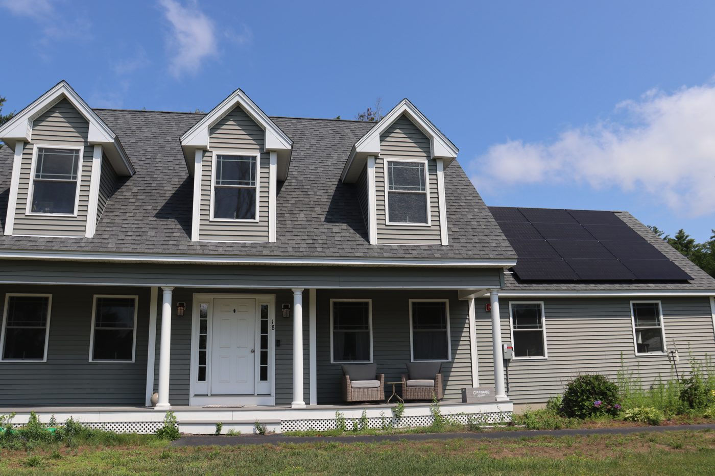 Front porch view showing the solar array over the right roof wing
