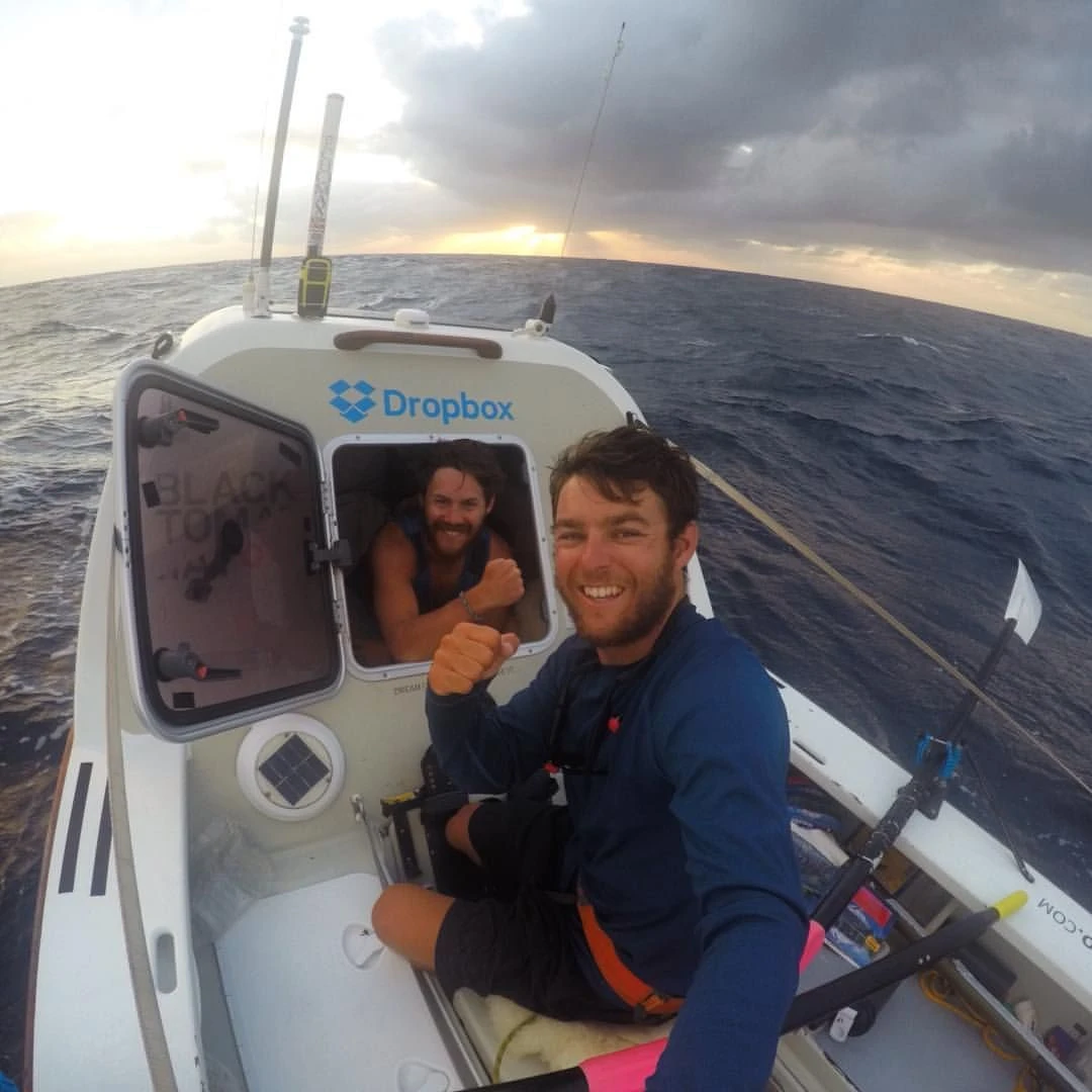 Tom Caulfield and James Whittle on board their ocean rowing boat near the end of their Atlantic crossing