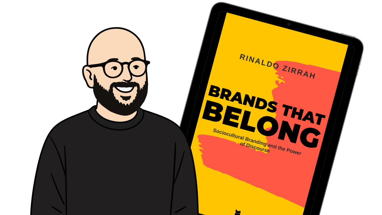 Illustration of a smiling bald man with glasses and a black beard wearing a black shirt.
