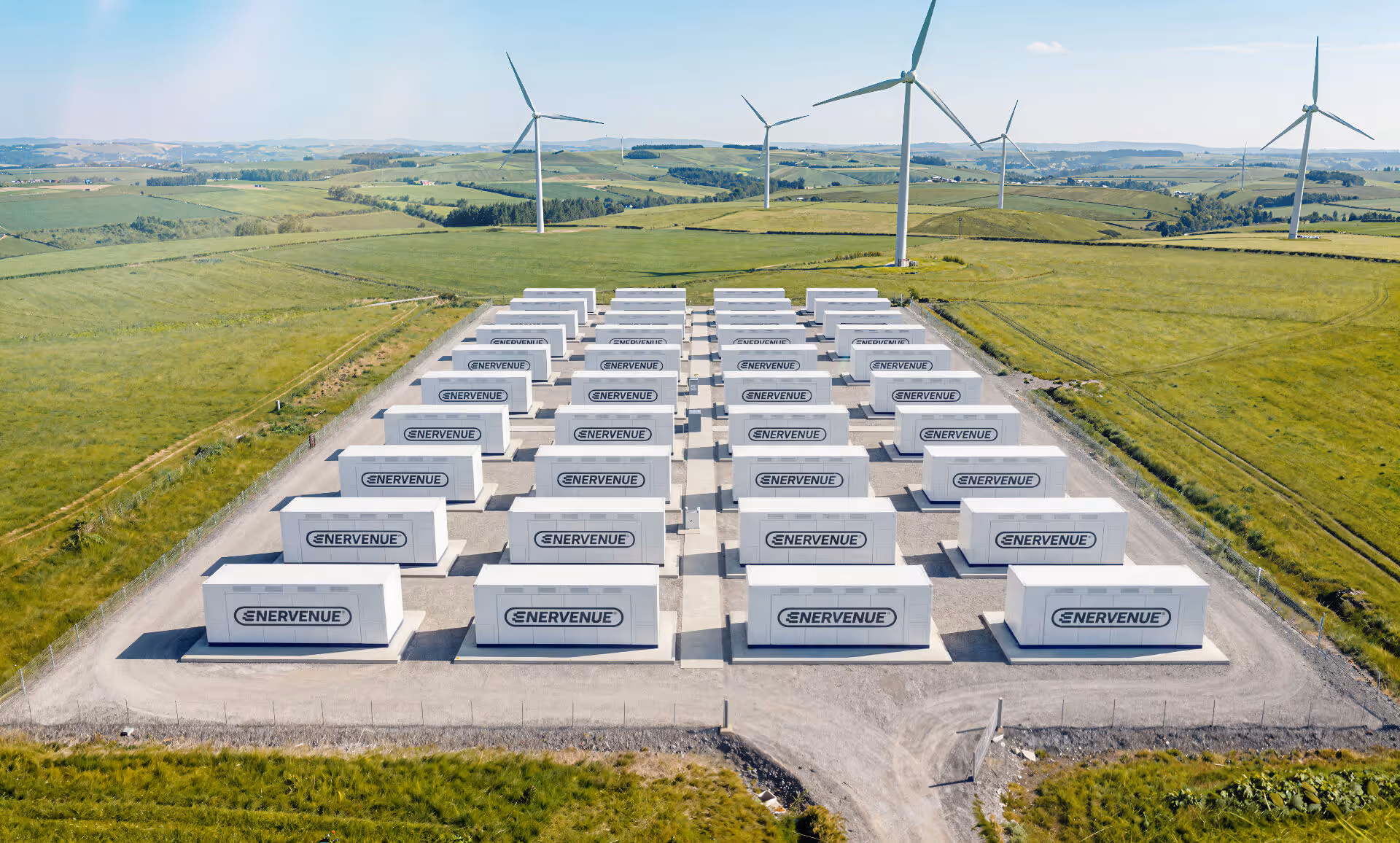 Aerial view of a wind farm paired with EnerVenue energy storage, illustrating grid-scale deployment