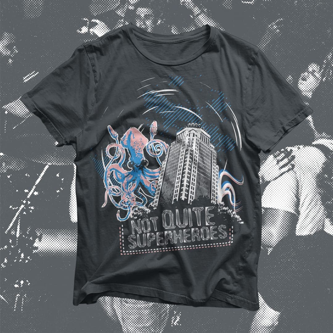 Dark t-shirt mockup illustrated with an octopus wrapped around a city skyline and the text "Not Quite Superheroes."