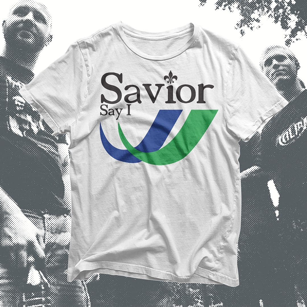 White t-shirt mockup with the "Savior Say I" logo in blue and green.