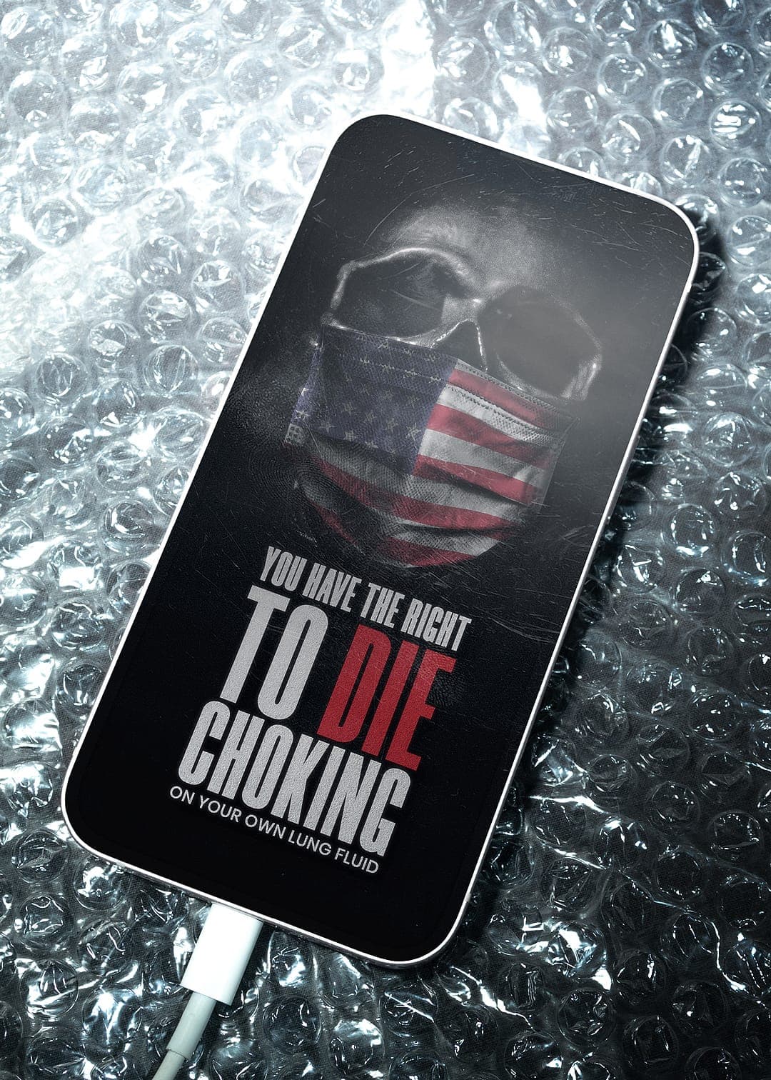 Smartphone mockup on bubble wrap displaying a skull in an American-flag mask with the text "You have the right to die choking on your own lung fluid."
