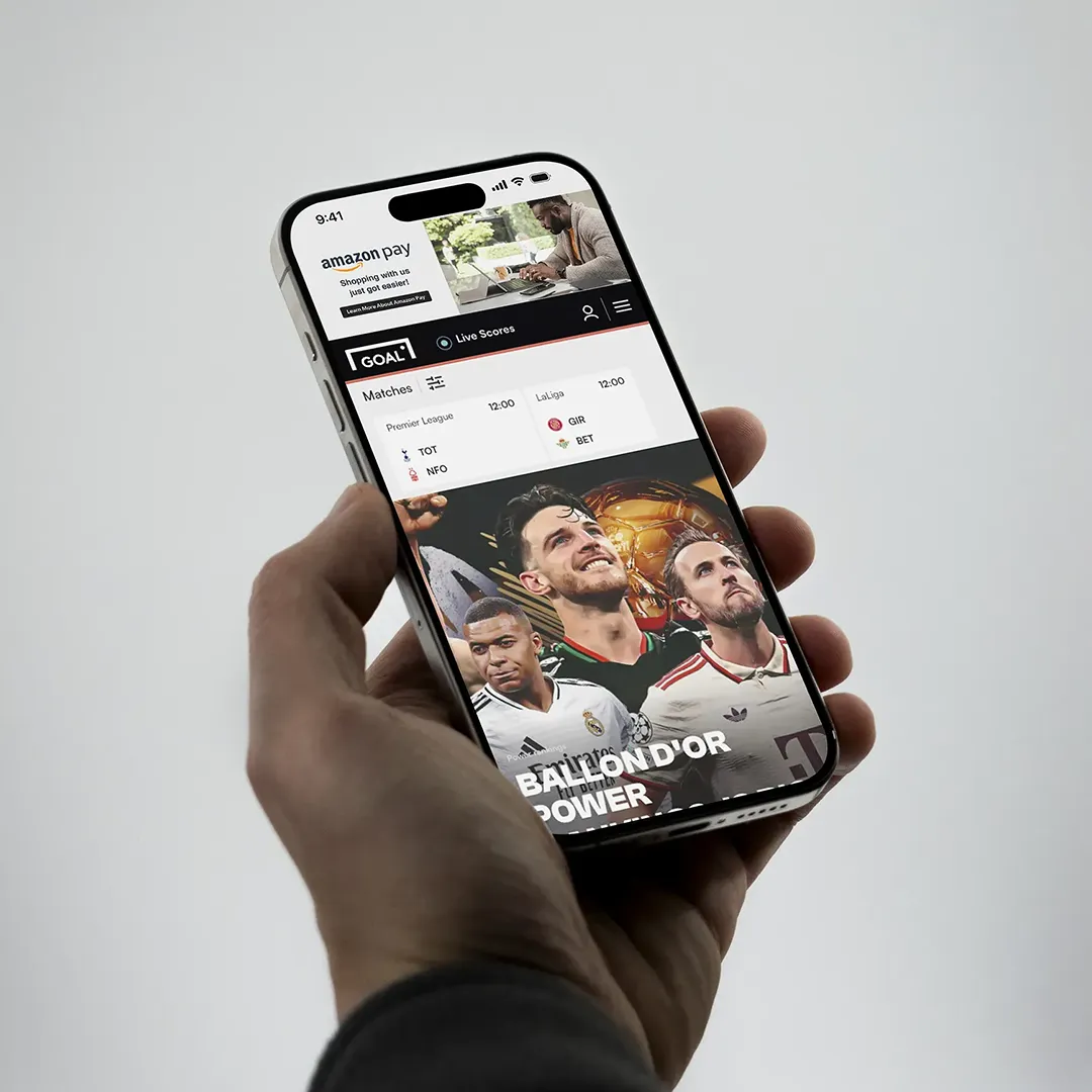 Amazon Pay display ad served at the top of the Goal.com soccer app on iPhone, reading "Shopping with us just got easier!" with a Learn More button — shown above live Premier League and LaLiga match scores and Ballon d'Or editorial coverage.