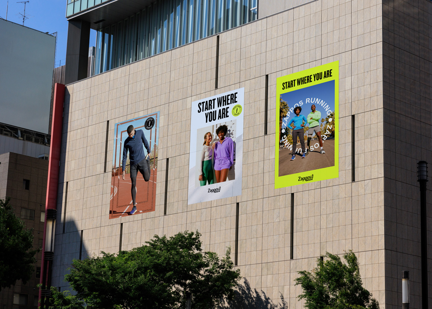 Zappos "Start Where You Are" running campaign — three large-format outdoor posters displayed on a building exterior, showcasing Zappos Running brand creative across track, lifestyle, and outdoor running themes.