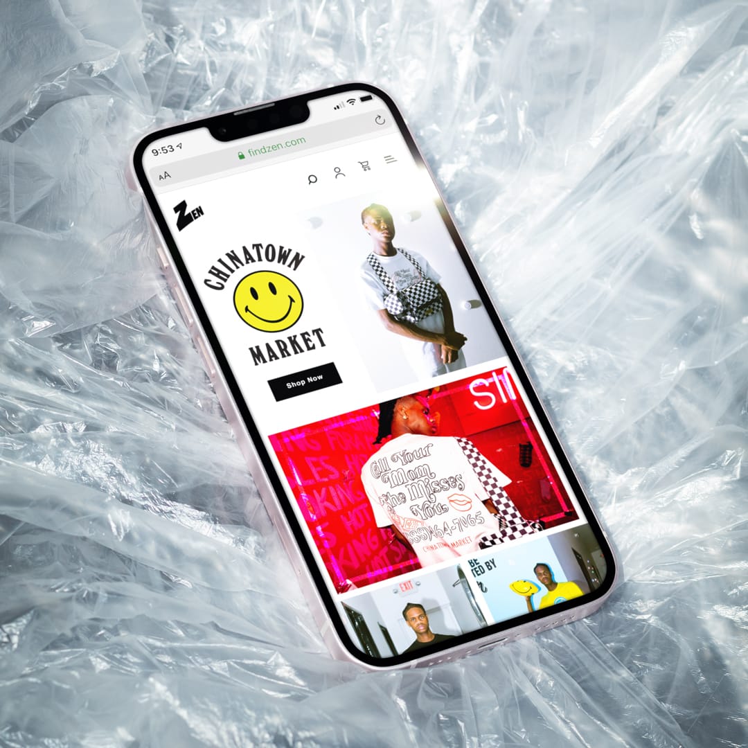 Phone mockup on plastic wrap showing Zen's Chinatown Market page with a smiley-face logo and streetwear photos.