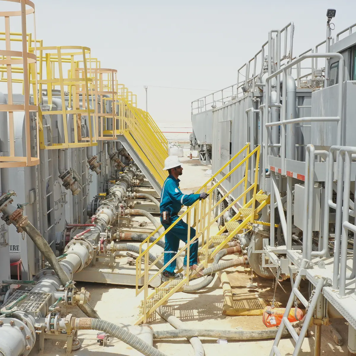 Technician working on acid chemistry manifold and piping