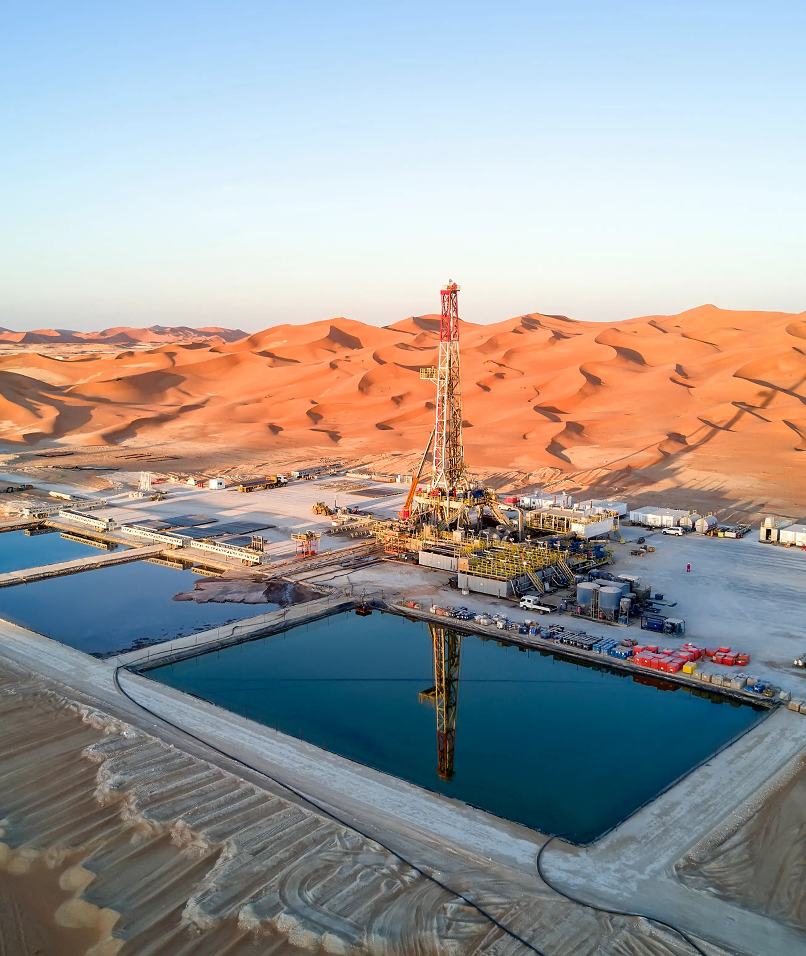 Aerial panorama of a desert drilling rig and reserve pits