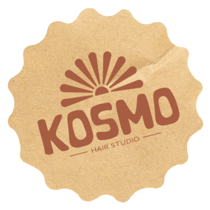 Brown textured seal-shaped emblem with a stylized sunburst above the bold word 'KOSMO' and smaller text 'HAIR STUDIO' beneath it.