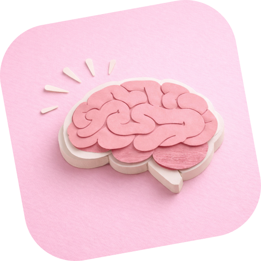 Pink wooden brain model on a light pink background with rays suggesting an idea.