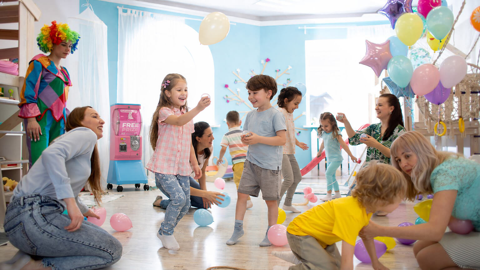 Young girls smiling and playing with balloons at a kids princess party