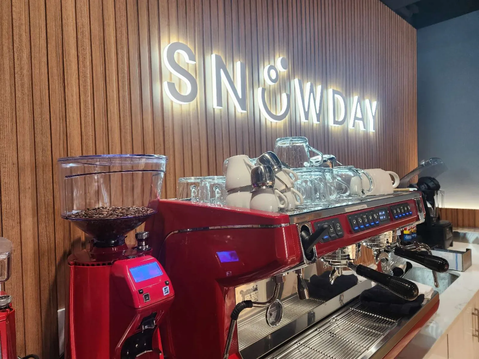 Espresso bar and wood-slat feature wall in the completed Snowday dessert cafe refresh in Toronto