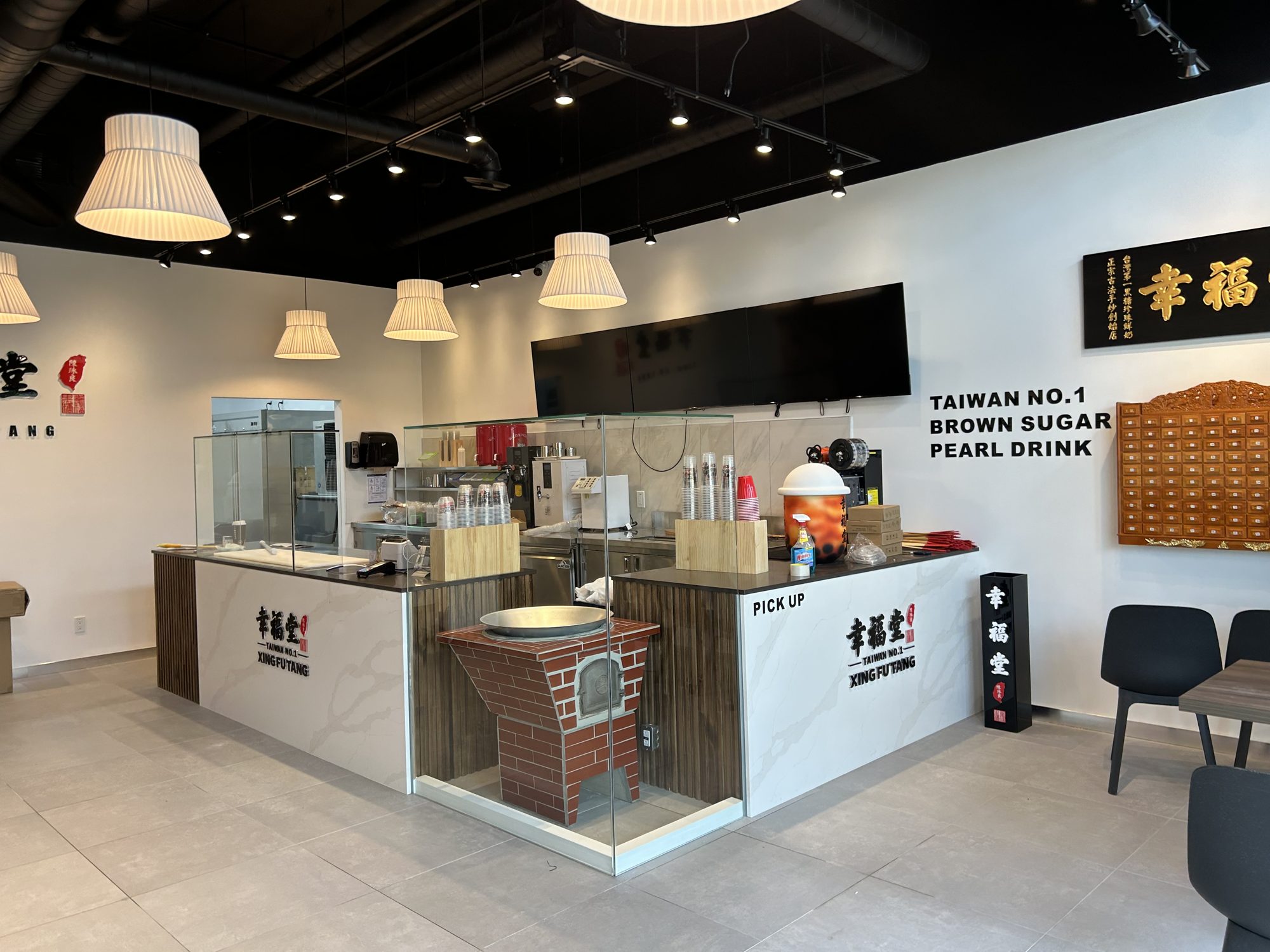 Completed bubble tea shop service counter and dining room in a 1,500 sf Mississauga build-out